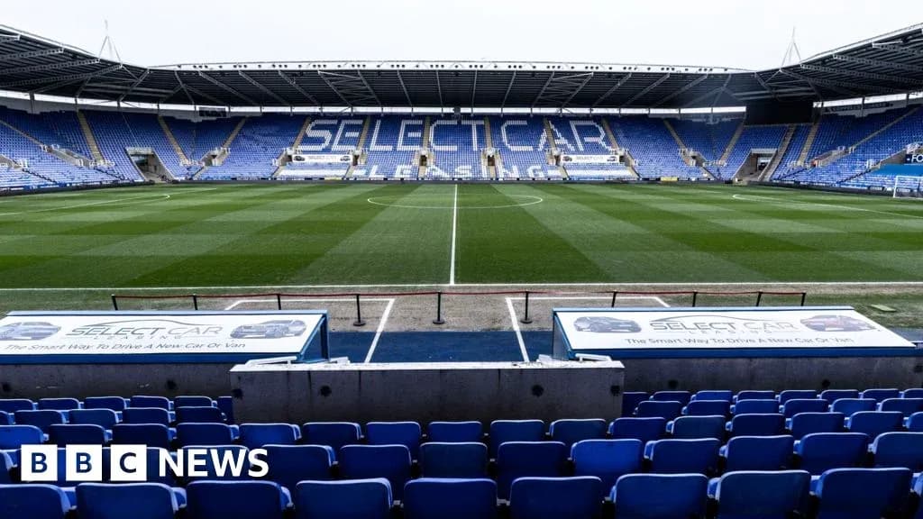 Empty football stadium with blue seats and pitch Empty football stadium with blue seats and pitch