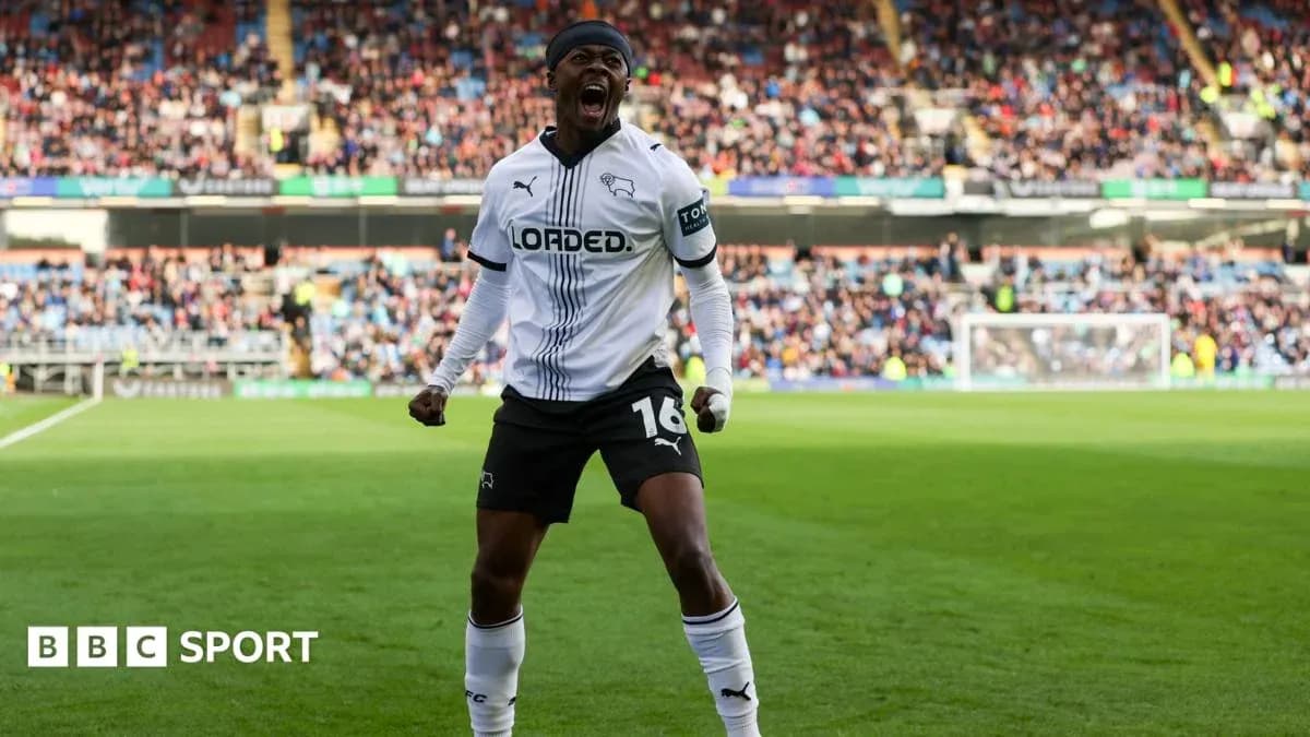 Player celebrating in Derby County jersey on pitch Player celebrating in Derby County jersey on pitch