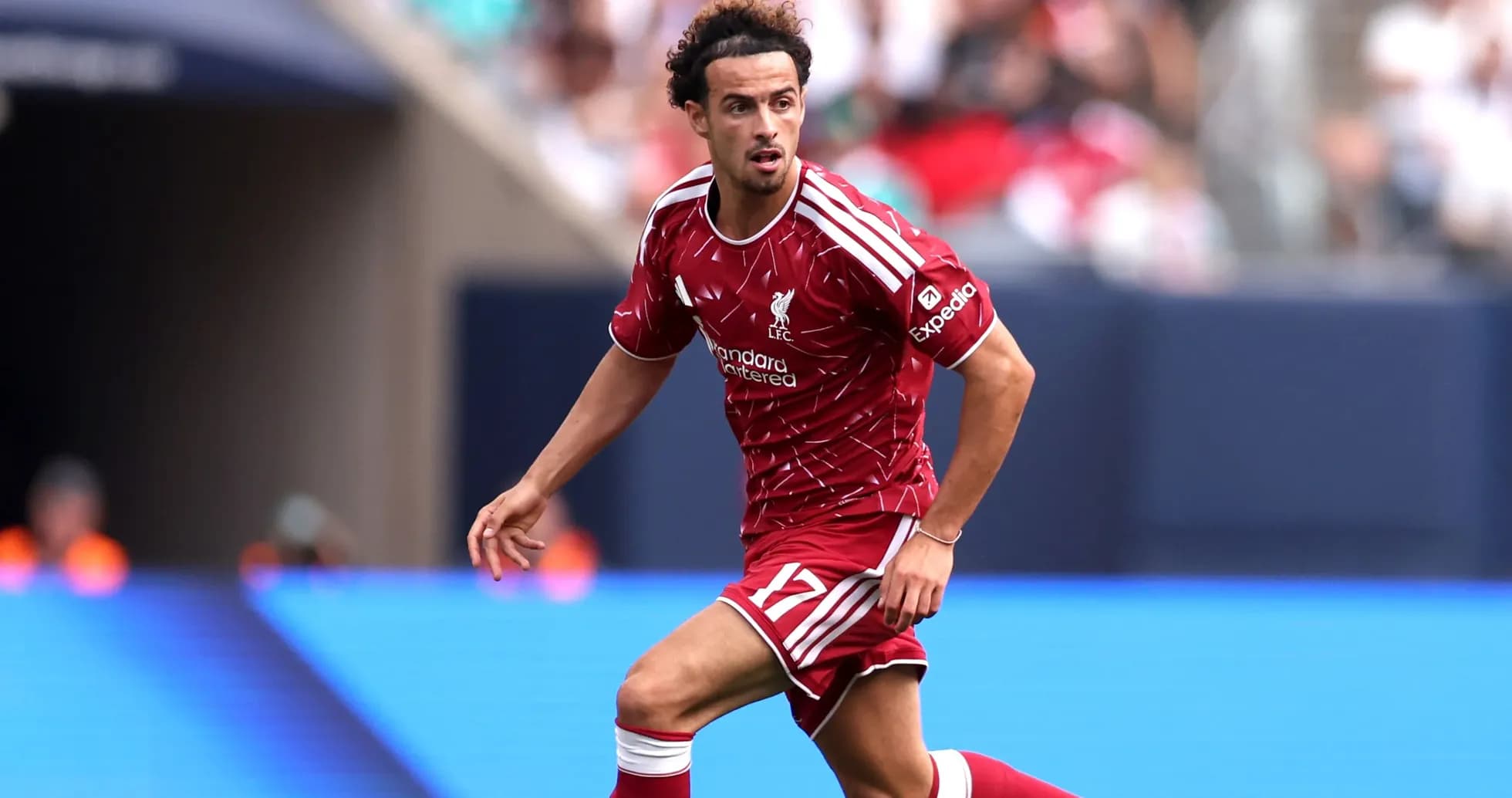 Player running with ball during match for Liverpool Player running with ball during match for Liverpool
