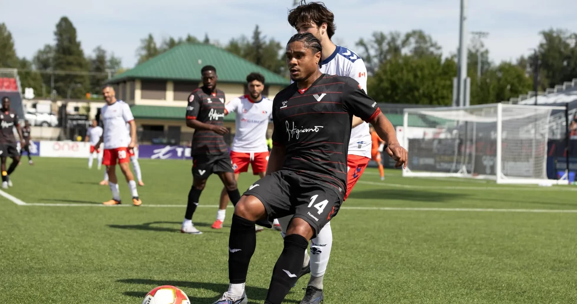 Player in black jersey controlling the ball Player in black jersey controlling the ball