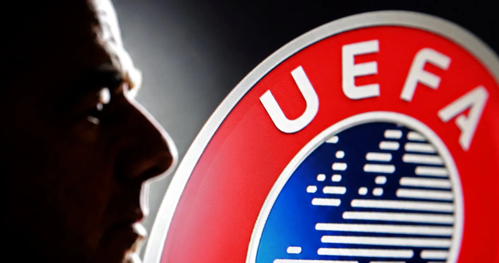 Profile silhouette near UEFA logo backdrop Profile silhouette near UEFA logo backdrop