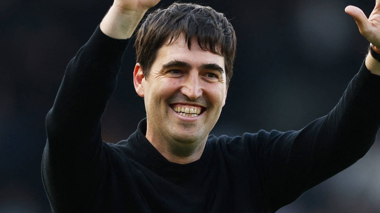 Coach celebrating with raised arms at stadium Coach celebrating with raised arms at stadium