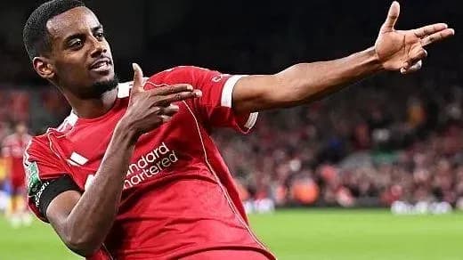 Player celebrating a goal in Liverpool jersey Player celebrating a goal in Liverpool jersey