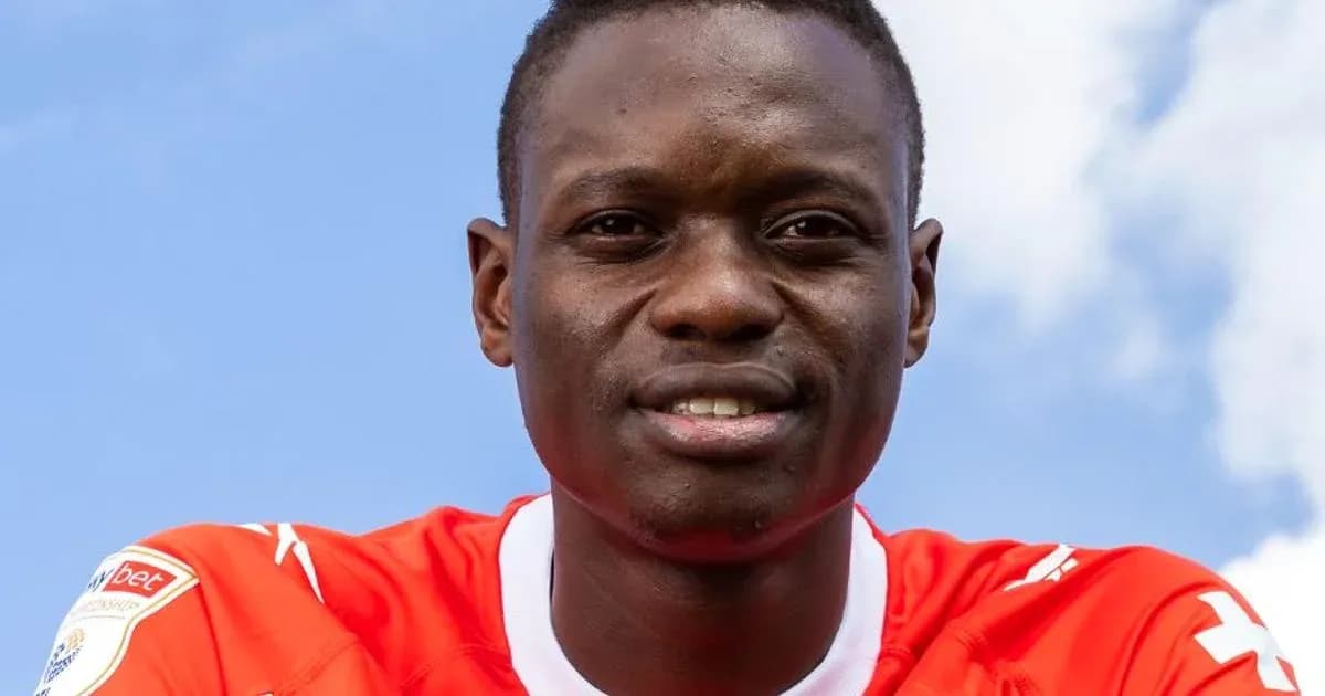 Player wearing red jersey with blue sky background Player wearing red jersey with blue sky background