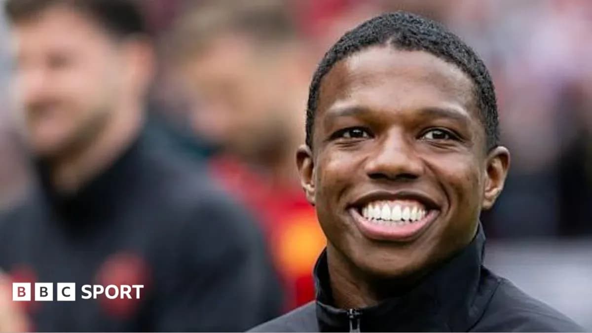 Smiling player in warm-up attire before match Smiling player in warm-up attire before match