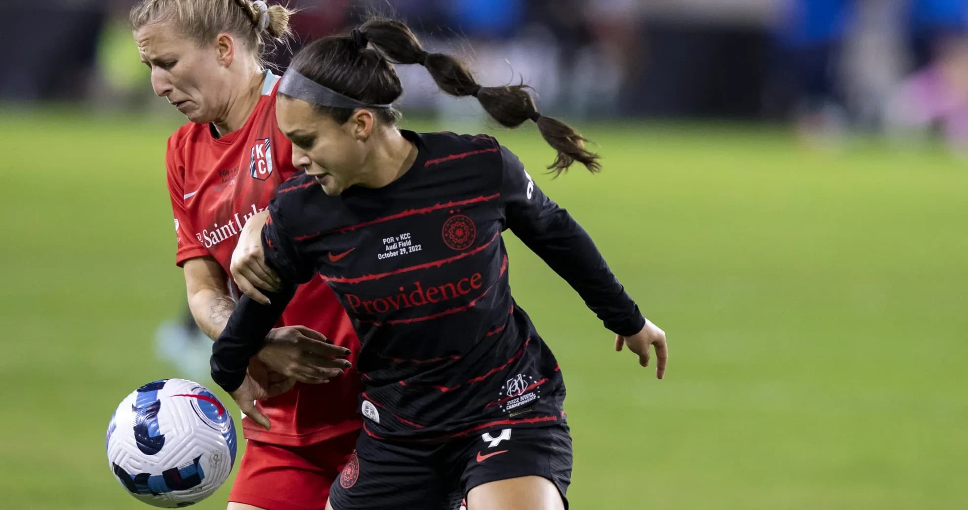 Kansas City and Portland Thorns players competing for ball Kansas City and Portland Thorns players competing for ball