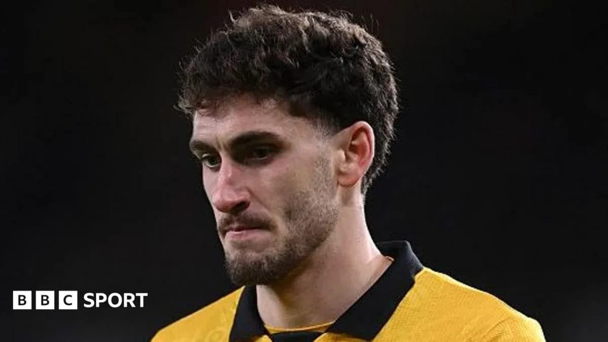 Player in yellow jersey looking down after match Player in yellow jersey looking down after match