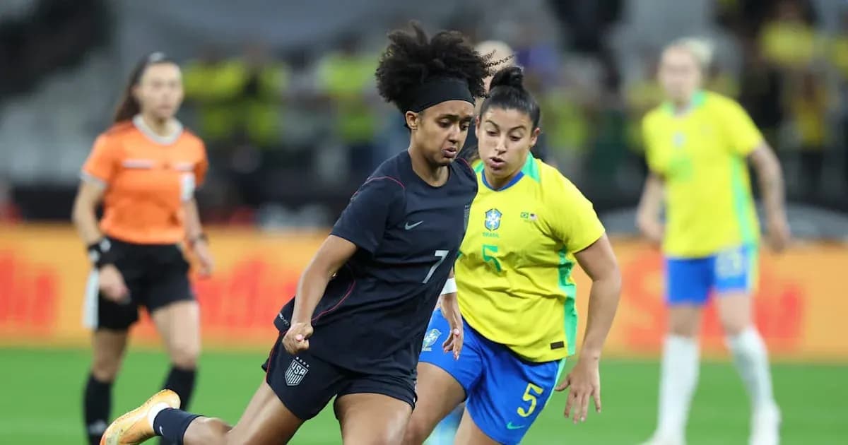 US player dribbling past Brazilian defender in match US player dribbling past Brazilian defender in match