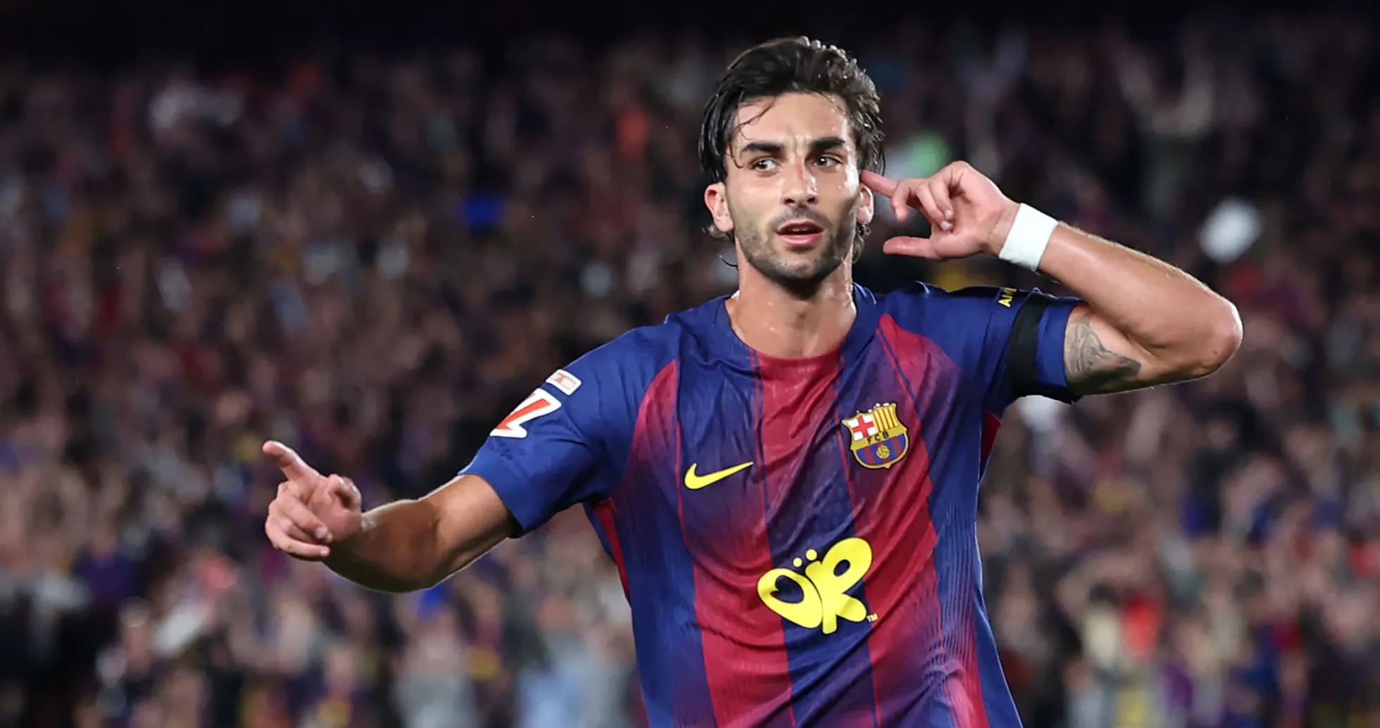 Player celebrating a goal with fans in stadium Player celebrating a goal with fans in stadium