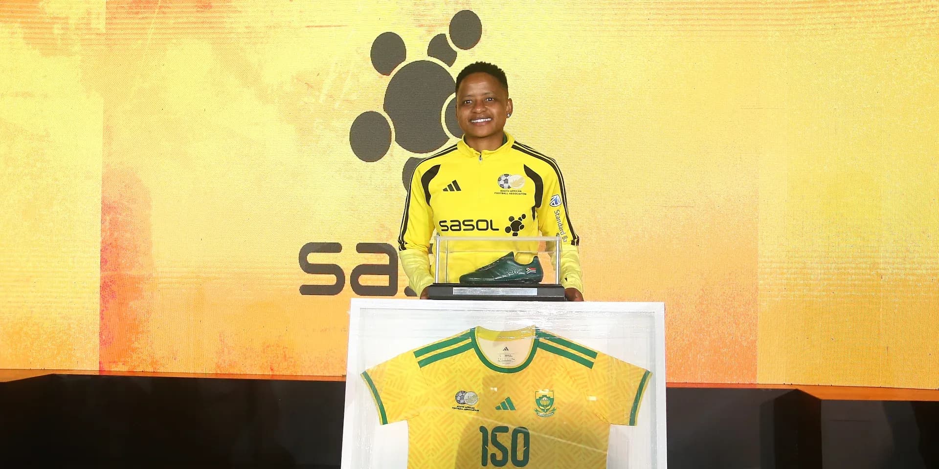Player presenting jersey and shoe at event Player presenting jersey and shoe at event