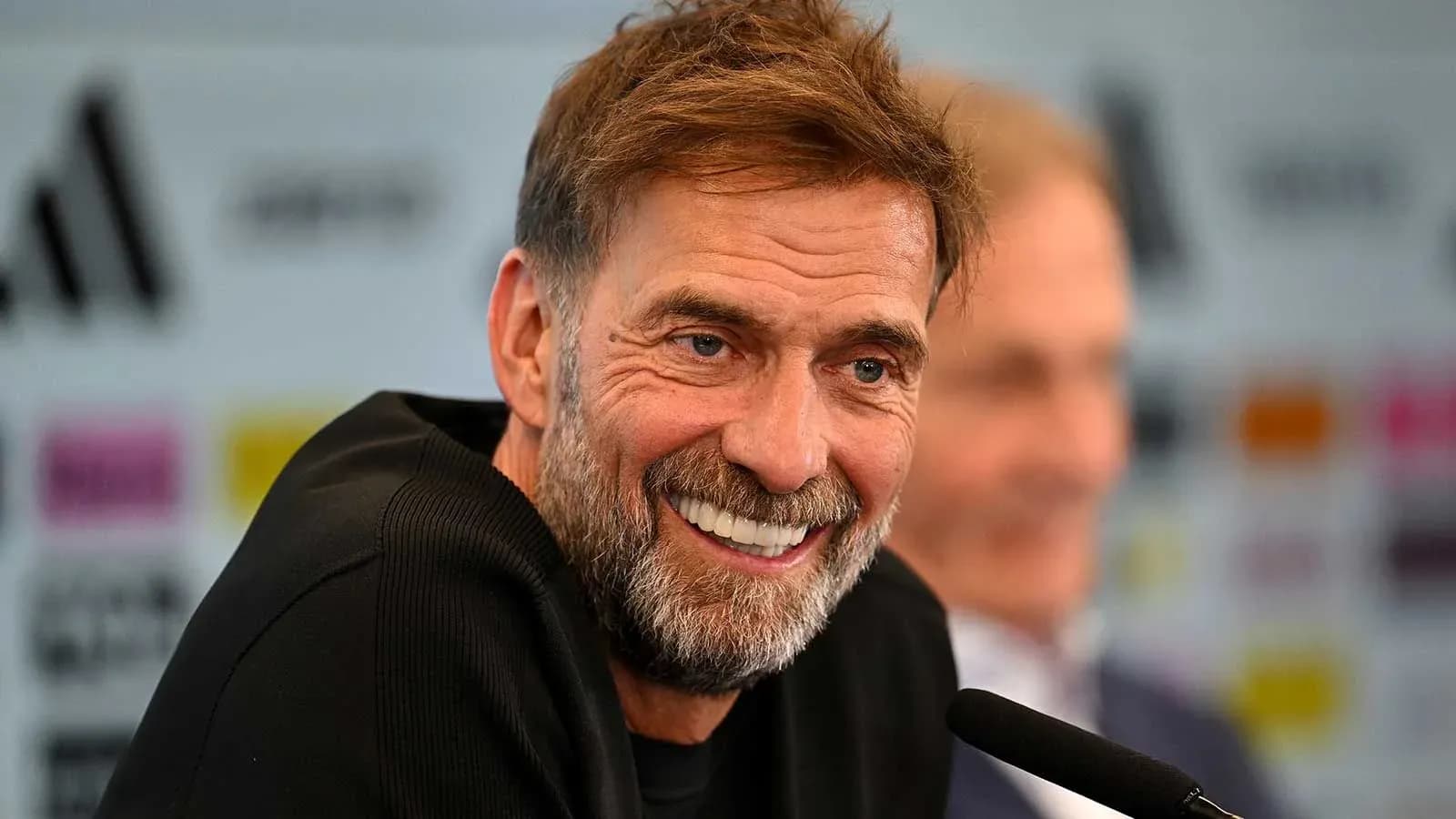 Manager smiling at press conference with microphone Manager smiling at press conference with microphone