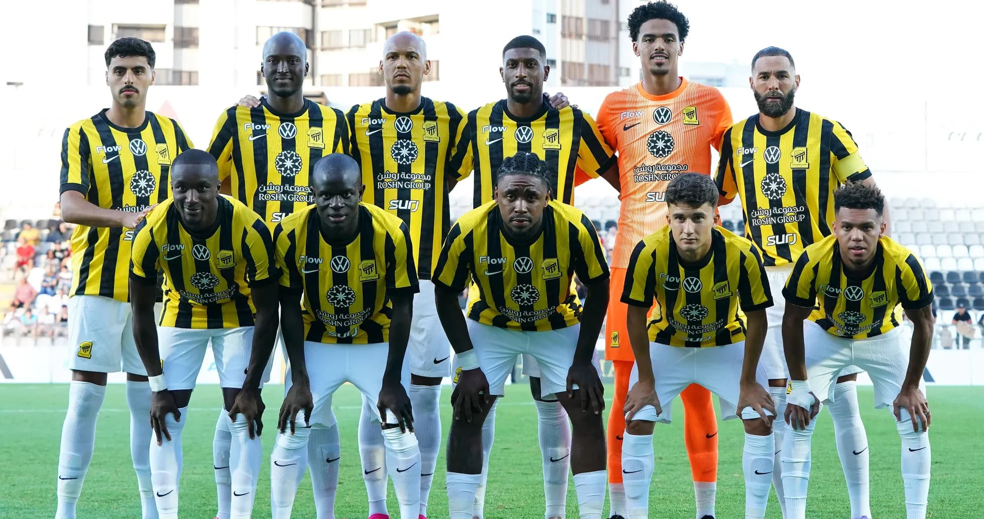 Football team posing in yellow and black jerseys Football team posing in yellow and black jerseys