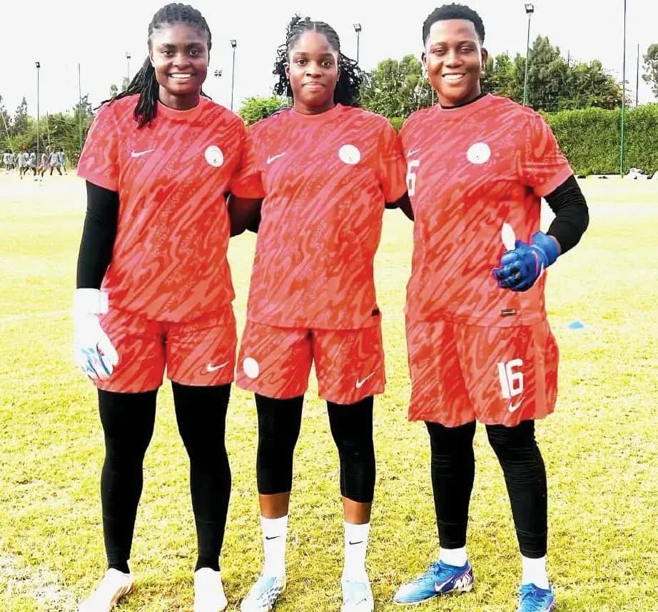 Three female football players in red training kits Three female football players in red training kits