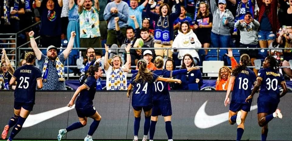 Seattle Reign FC celebrating a goal with fans Seattle Reign FC celebrating a goal with fans