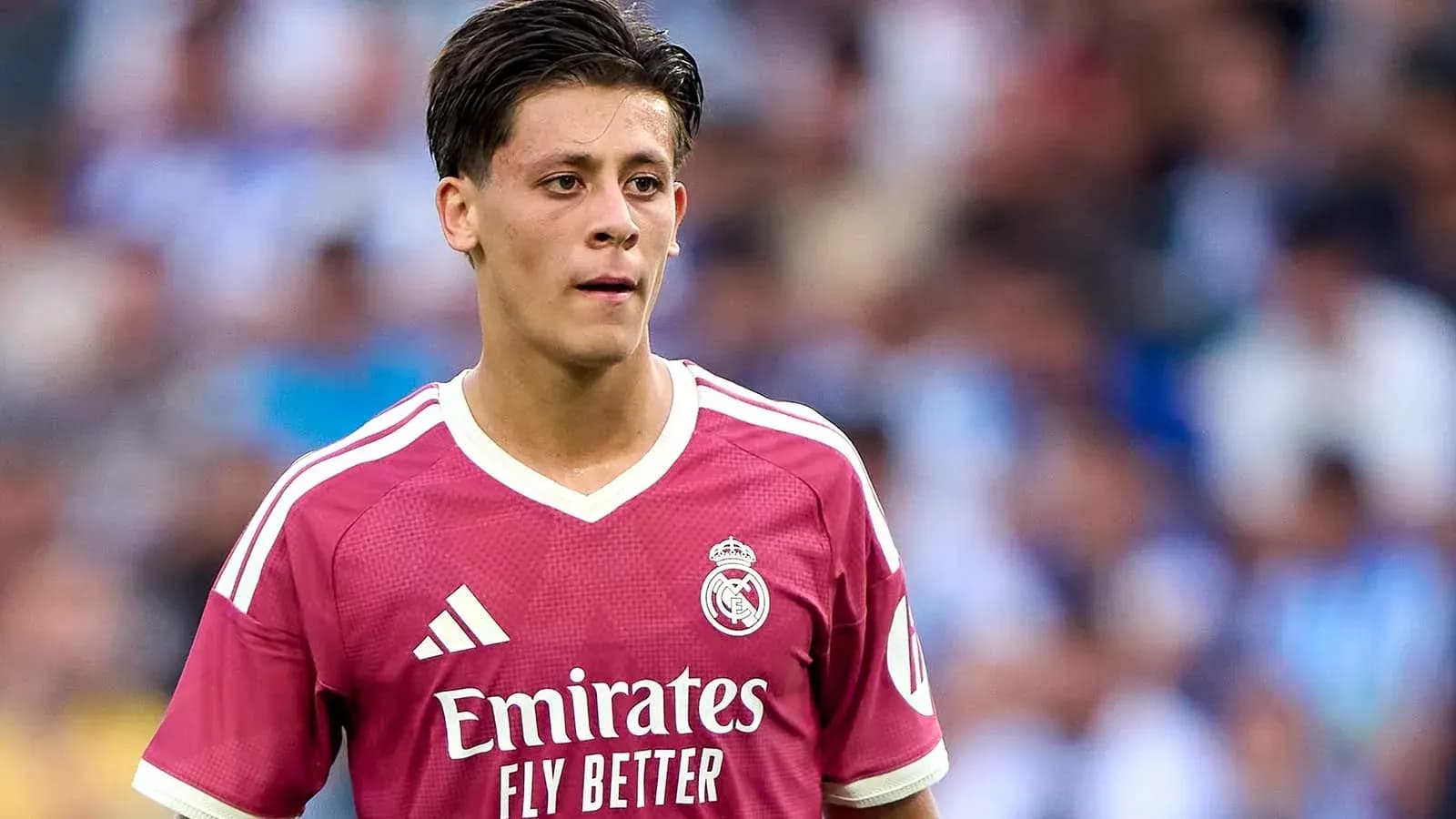 Player in pink Real Madrid jersey on the field Player in pink Real Madrid jersey on the field