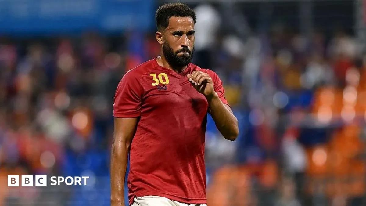 Player in red jersey walking off the field Player in red jersey walking off the field