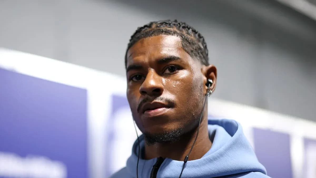 Athlete wearing headphones, looking at the camera Athlete wearing headphones, looking at the camera