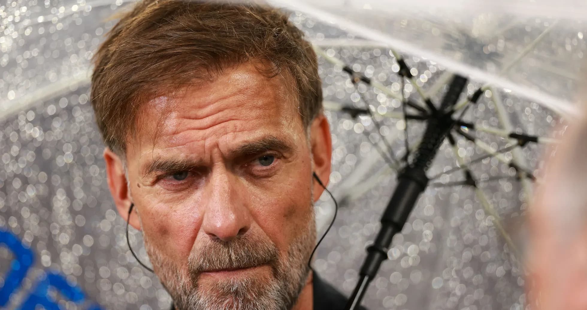 Man with umbrella in rainy press conference setting Man with umbrella in rainy press conference setting