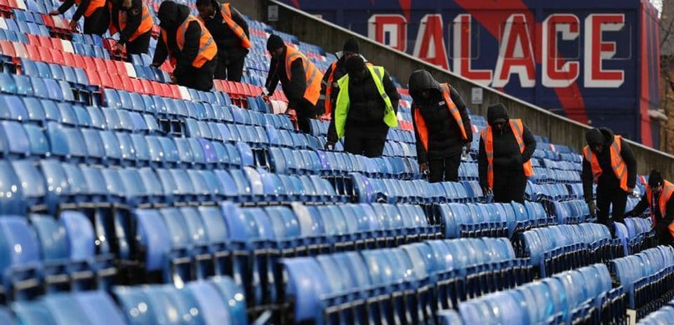 Staff cleaning stadium seats at Selhurst Park Staff cleaning stadium seats at Selhurst Park