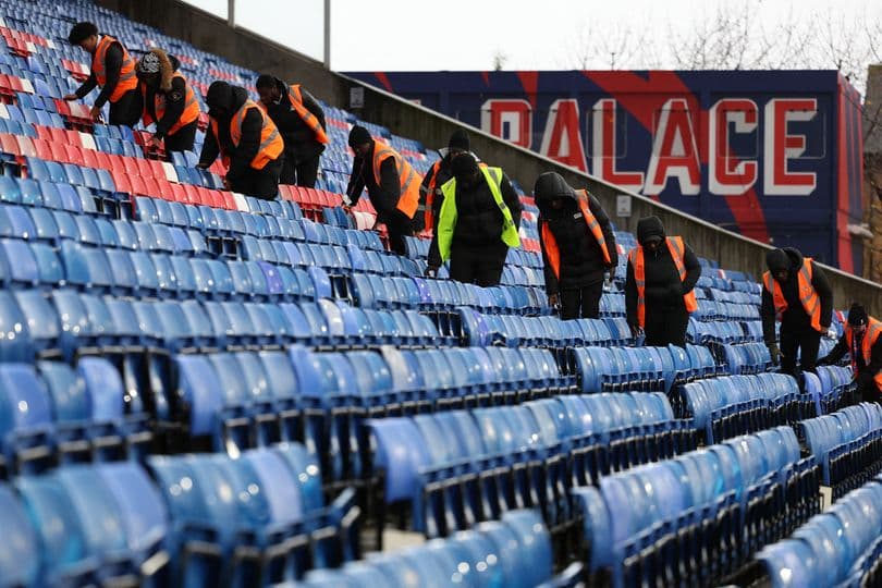 Staff cleaning stadium seats at Selhurst Park Staff cleaning stadium seats at Selhurst Park
