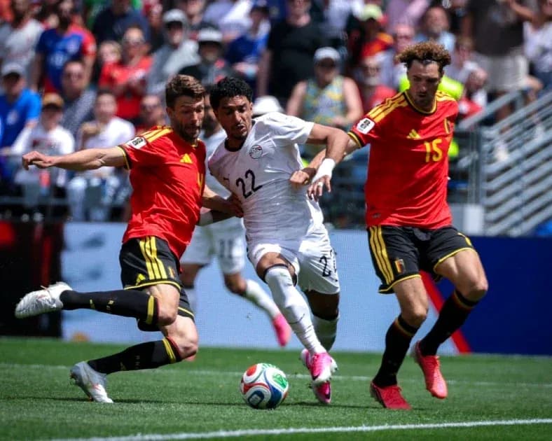 Players from Egypt and Belgium competing for the ball Players from Egypt and Belgium competing for the ball