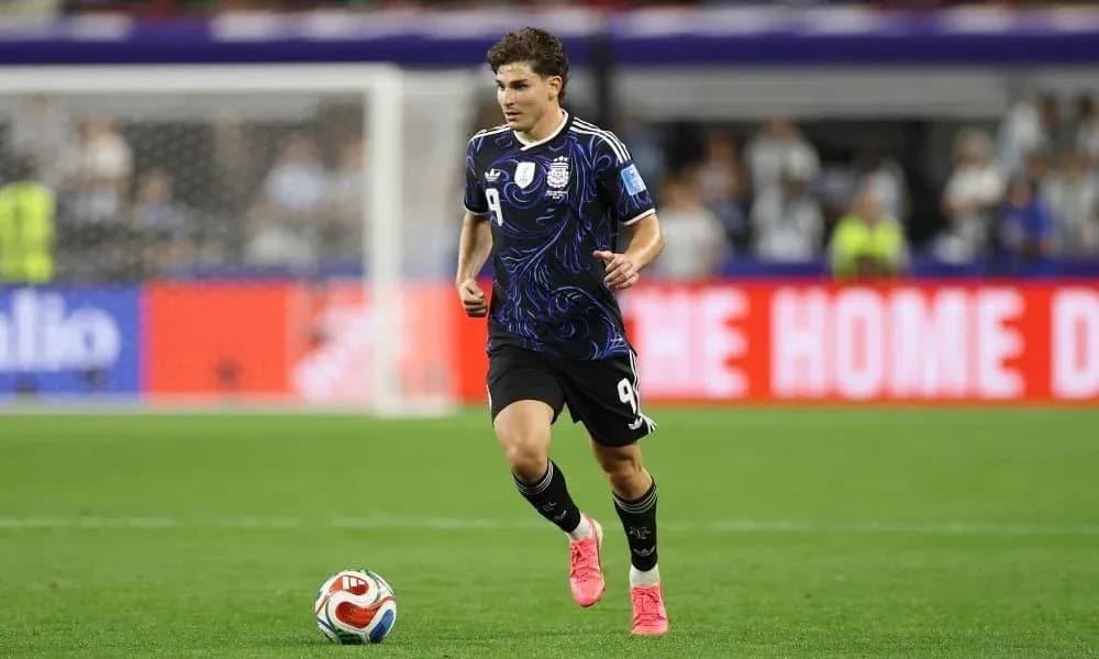 Player in black kit running on football pitch Player in black kit running on football pitch