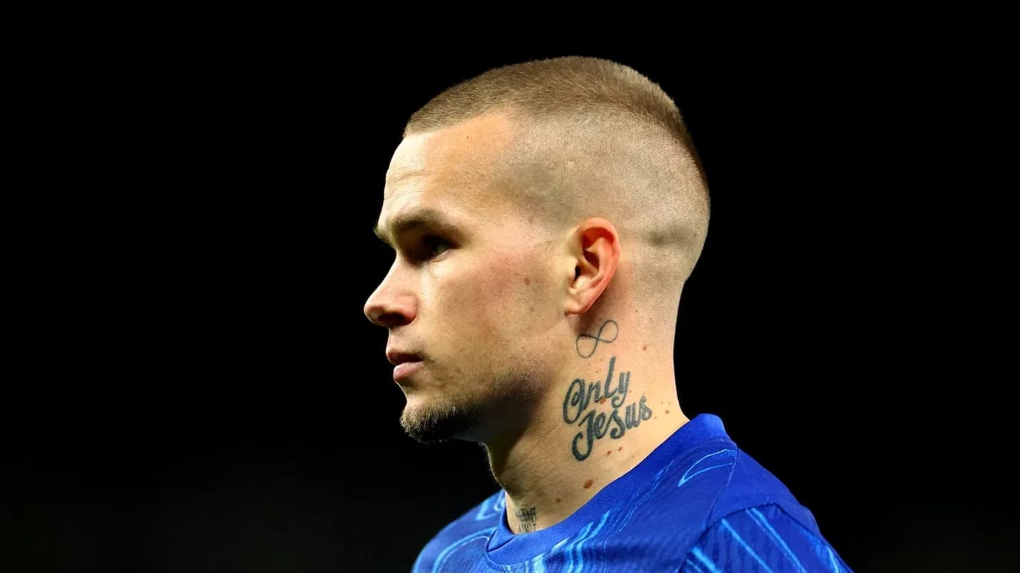 Player with tattoos wearing blue jersey in profile Player with tattoos wearing blue jersey in profile