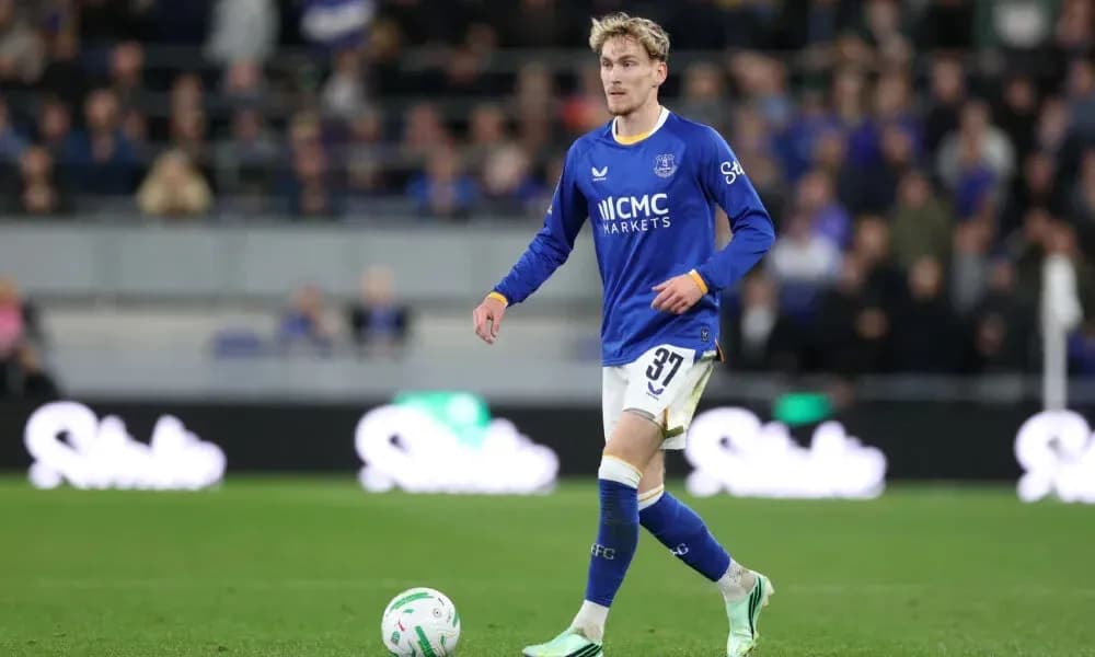 Player in blue kit walking on the pitch Player in blue kit walking on the pitch
