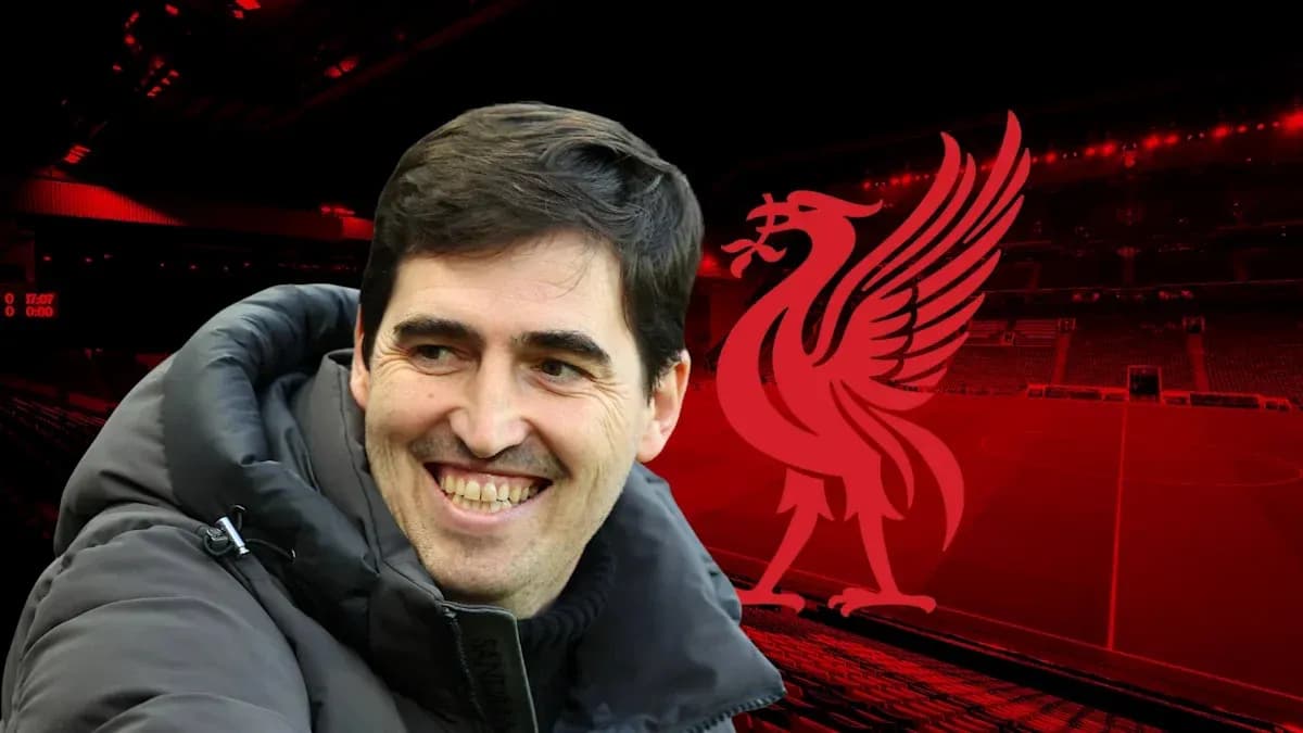 Man smiling in front of Liverpool FC logo Man smiling in front of Liverpool FC logo