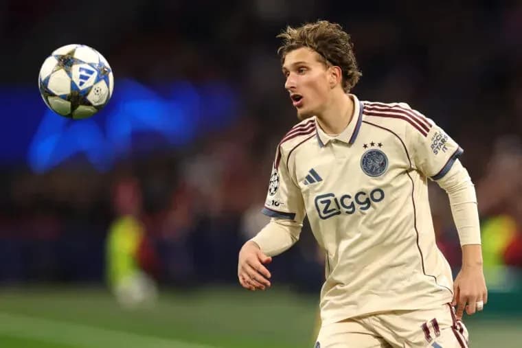 Player from Ajax chasing a ball during match Player from Ajax chasing a ball during match