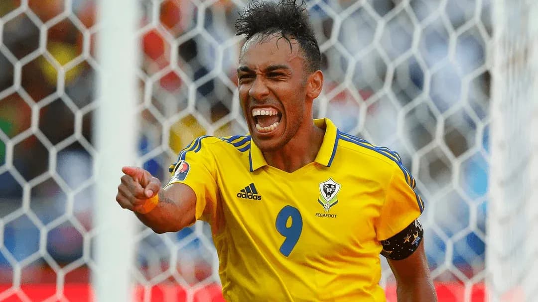 Player celebrating a goal in yellow jersey Player celebrating a goal in yellow jersey