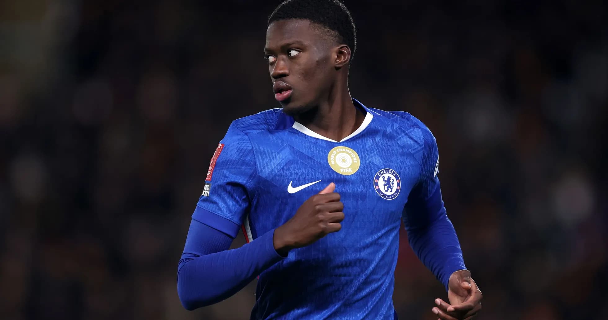 Player in blue Chelsea kit running during match Player in blue Chelsea kit running during match
