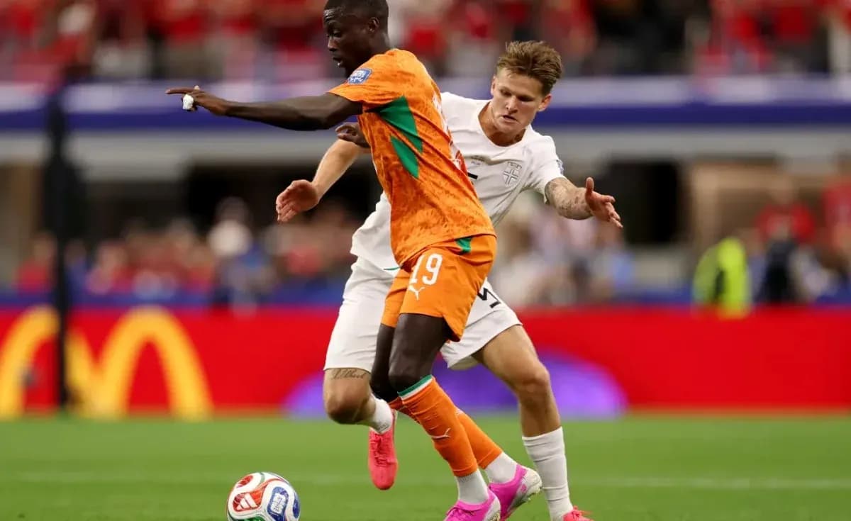 Player in orange jersey evading opponent in white jersey Player in orange jersey evading opponent in white jersey