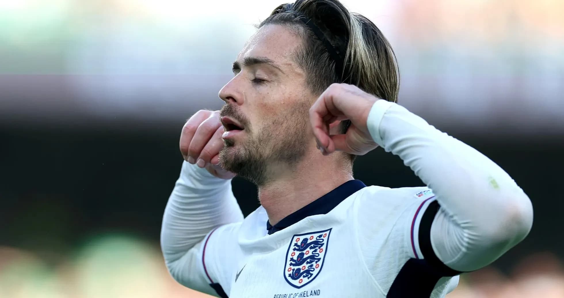 Player adjusting his headband during a match Player adjusting his headband during a match