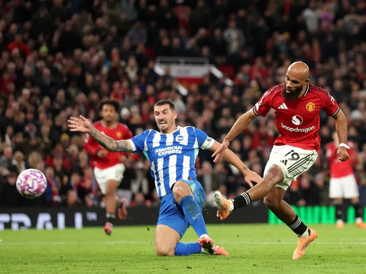 Brighton player tackles Manchester United player Brighton player tackles Manchester United player