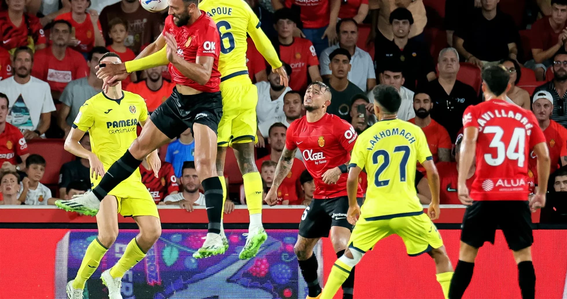 Mallorca player challenging Villarreal opponent for ball Mallorca player challenging Villarreal opponent for ball