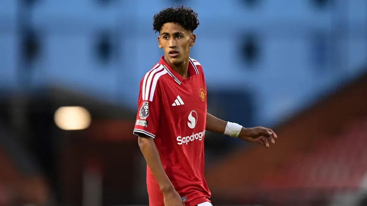 Player in red Manchester United kit on pitch Player in red Manchester United kit on pitch