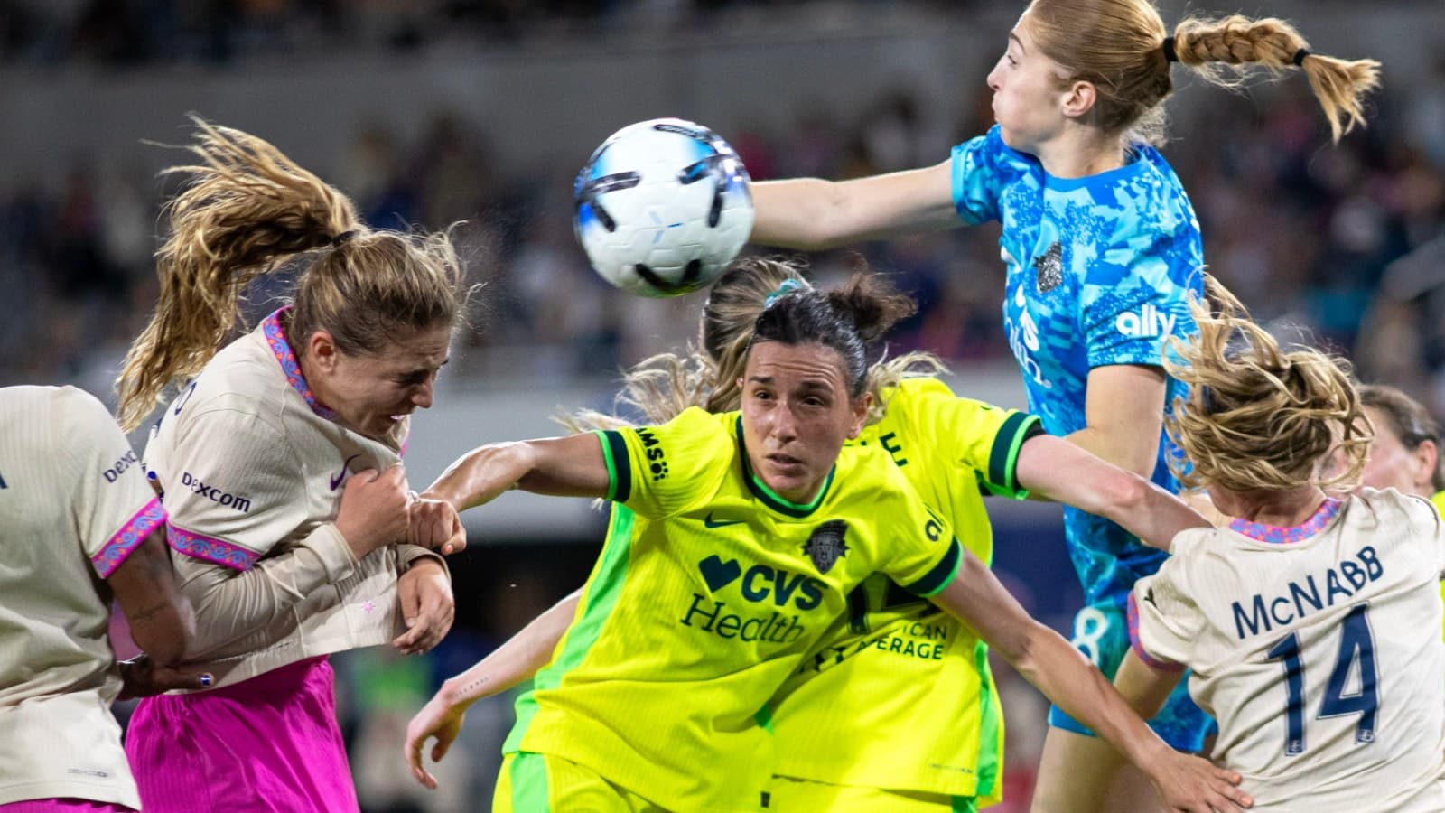 Players contesting a high ball during match Players contesting a high ball during match