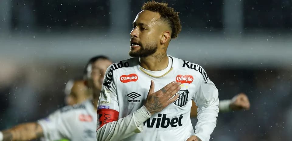 Player celebrating a goal during a rainy match Player celebrating a goal during a rainy match