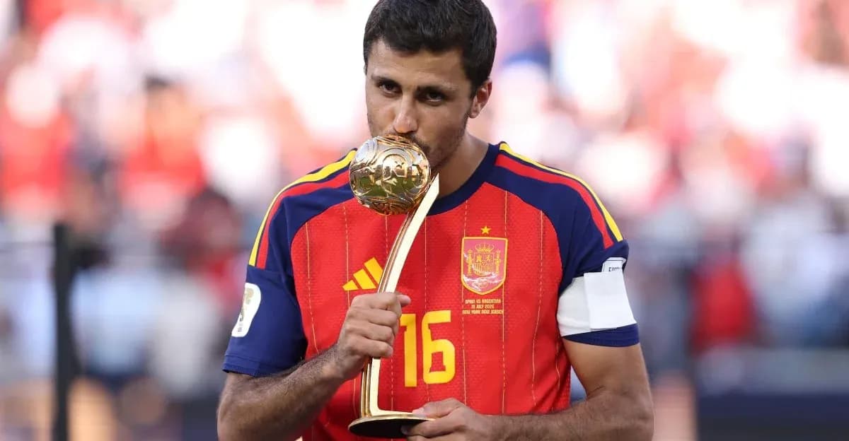 Player in Spain jersey holding trophy after victory Player in Spain jersey holding trophy after victory
