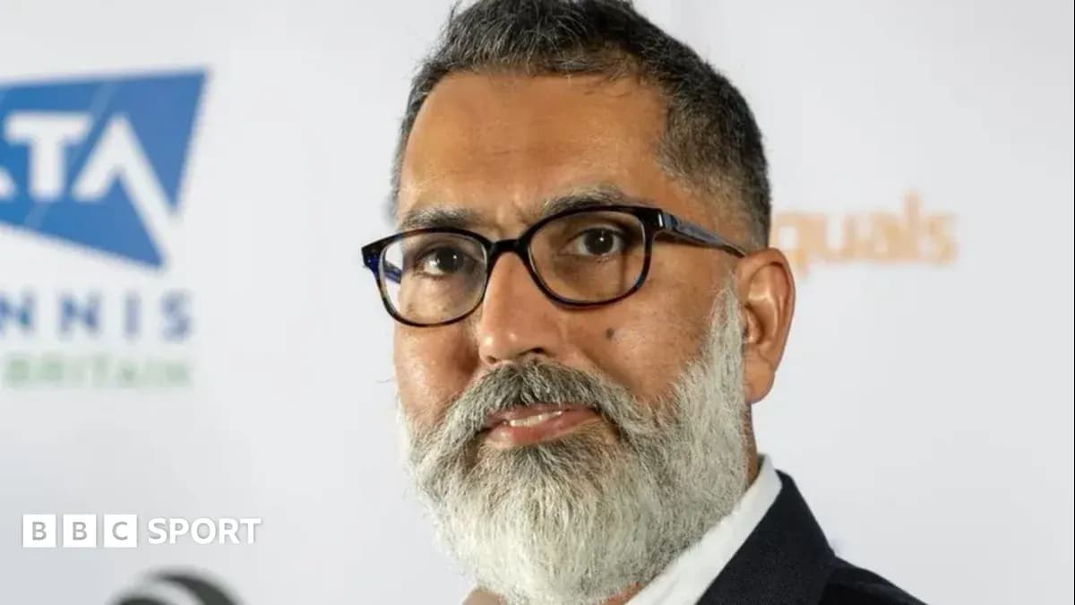 Man with glasses and beard at press conference Man with glasses and beard at press conference