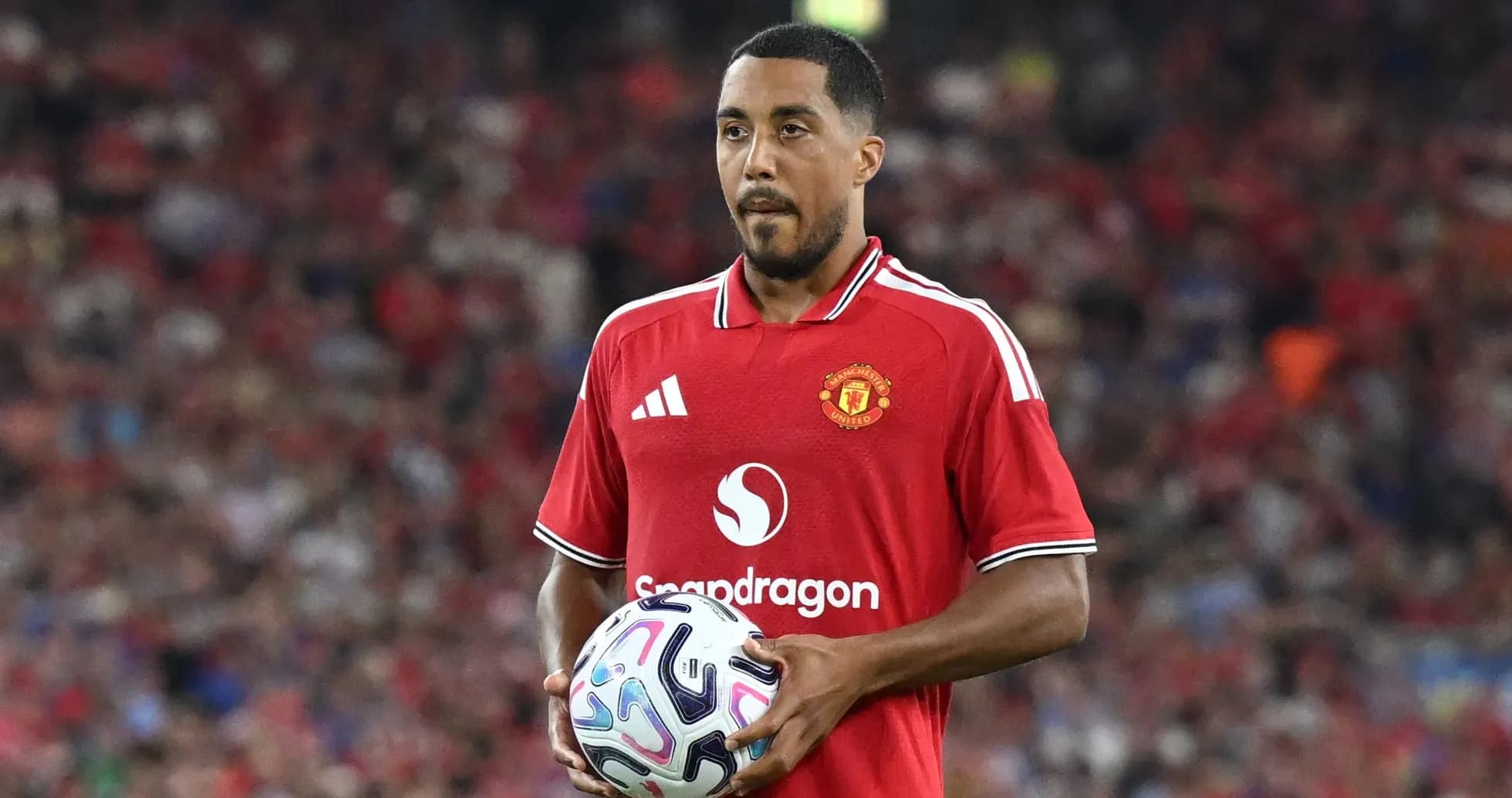 Player holding the ball in Manchester United jersey Player holding the ball in Manchester United jersey