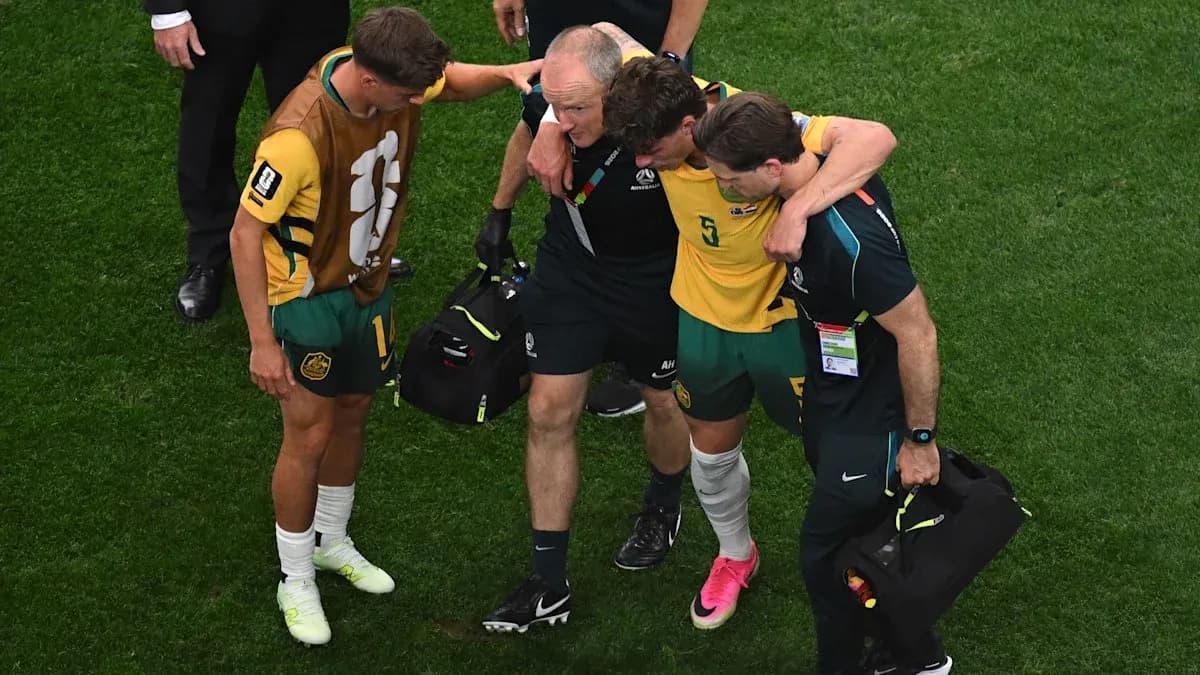 Player being assisted off the field by staff Player being assisted off the field by staff