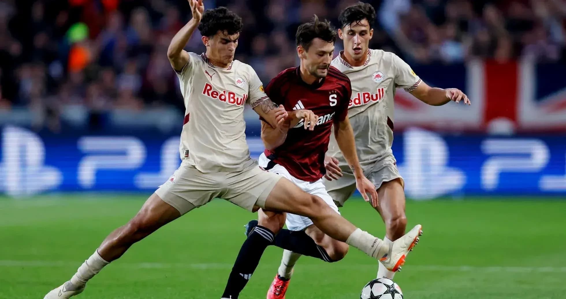 Players competing for the ball in UEFA match Players competing for the ball in UEFA match