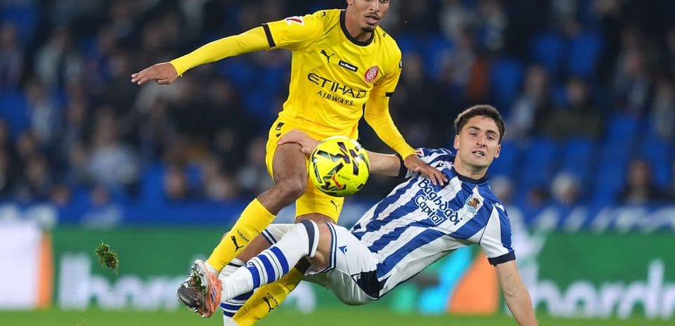 Girona player evading tackle from Real Sociedad player Girona player evading tackle from Real Sociedad player