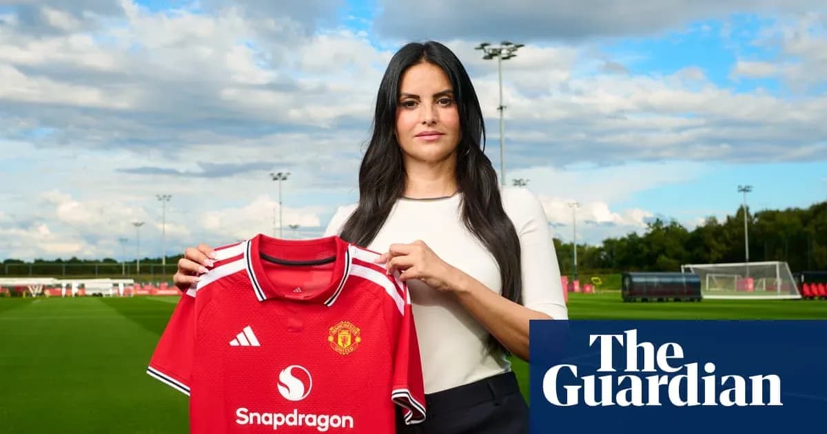 Person holding Manchester United jersey at training ground Person holding Manchester United jersey at training ground