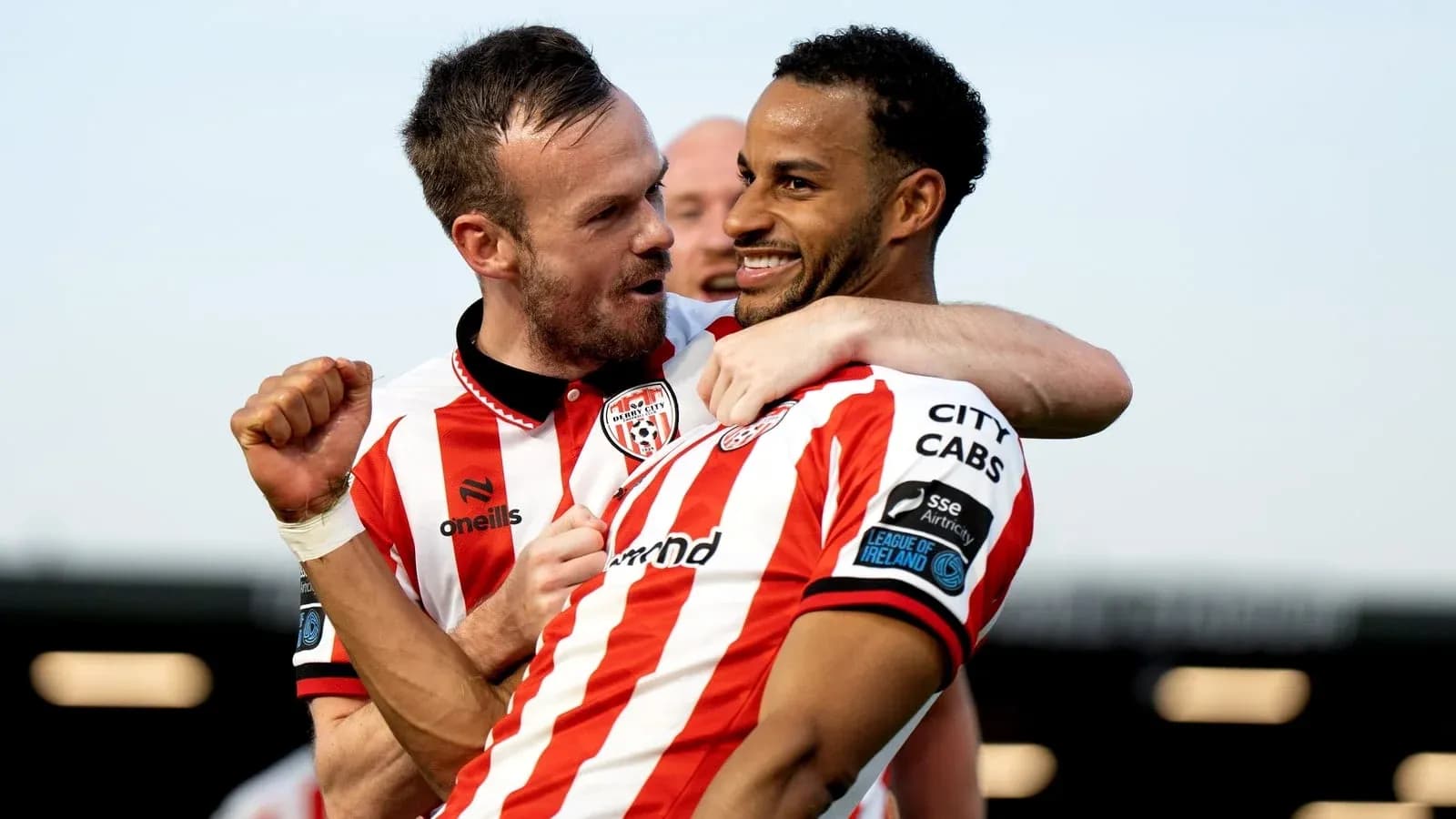 Two players celebrating a goal in team jerseys Two players celebrating a goal in team jerseys