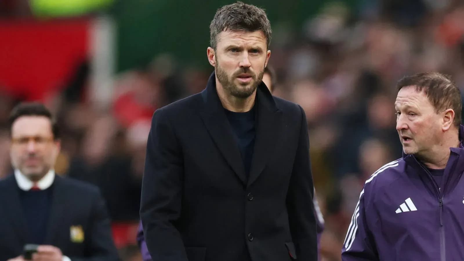 Coach walking on pitch with assistant during match Coach walking on pitch with assistant during match