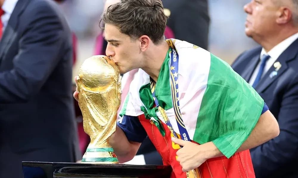Player kissing World Cup trophy wearing national flag Player kissing World Cup trophy wearing national flag