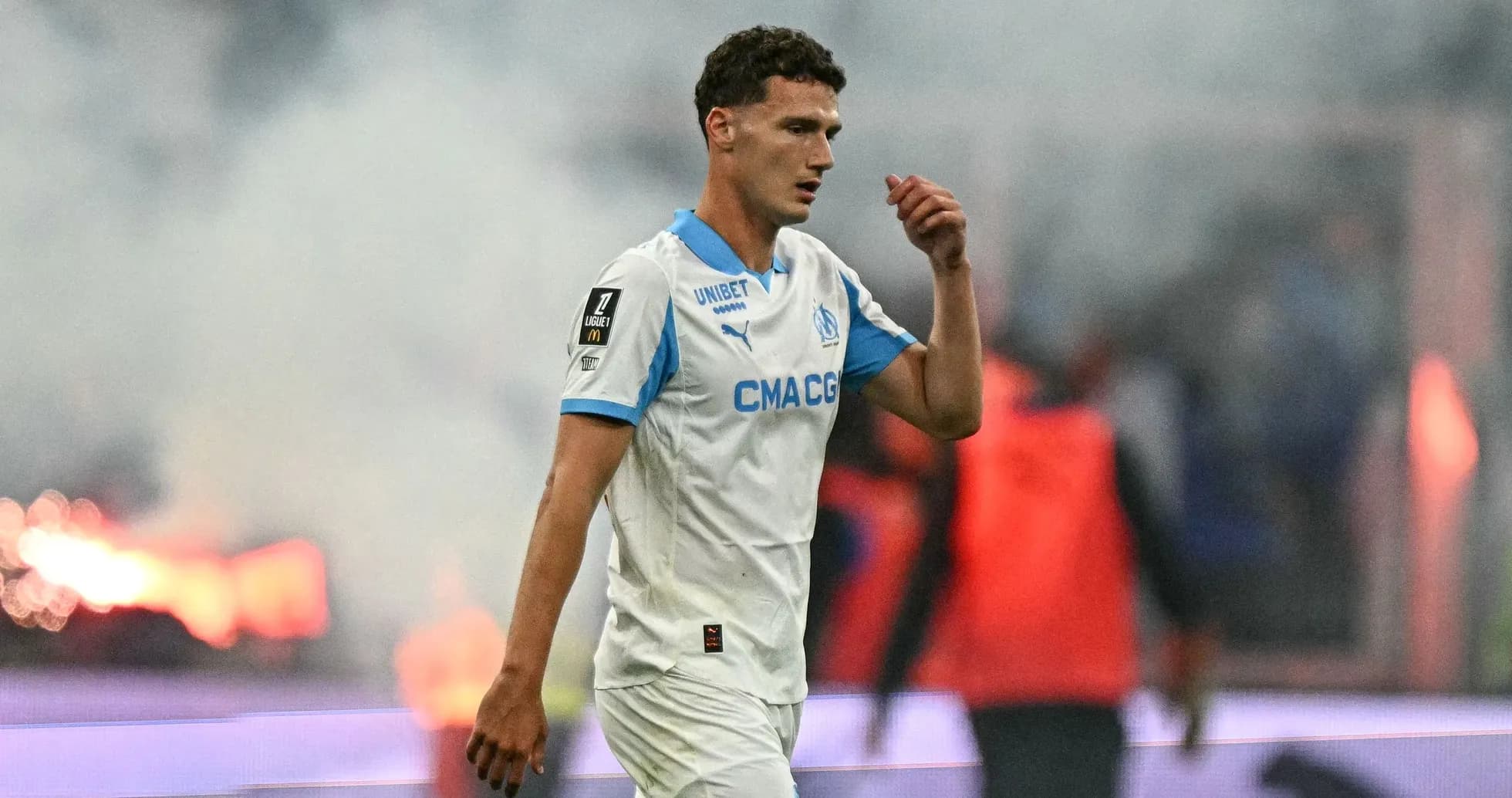 Player walking on pitch during match with smoke Player walking on pitch during match with smoke